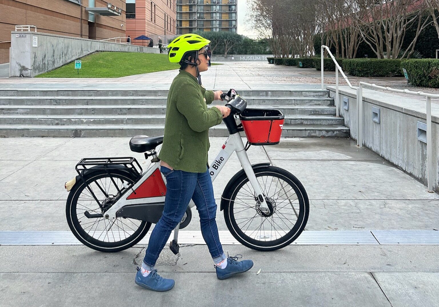 A person pushing a Metro Bike along